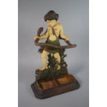 A Painted Cast Iron Novelty Stick Stand in the Form of Young Hercules Grappling with Snake,