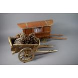 A Wooden Model of a Horse Drawn Gypsy Caravan Together with a Cart containing Pine Cones