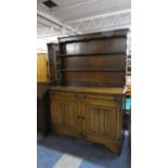 A Mid 20th Century Oak Linenfold Dresser with Two Drawers and Raised Plate Rack. 126cm Wide.