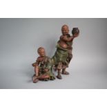 A Japanese Terracotta Figure Group, Monk Teasing Seated Scribe. 30.5cms High