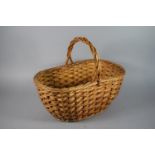 A Wicker Shopping Basket with Loop Handle, 47.5cm Long.