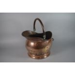 A Brass Helmet Shaped Coal Scuttle.