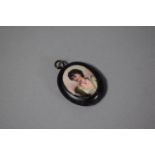 A Victorian Mourning Oval Ebonised Mounted Pendant with Hand Painted Miniature and Photograph to