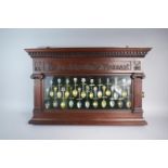 A Late 19th Century Mahogany Wall Hanging Display Containing 21 Enamelled Silver Souvenir Spoons.
