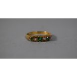 An 18 Carat Gold Ring set with Two Diamonds and Three Emeralds, Size M, 3.4gms