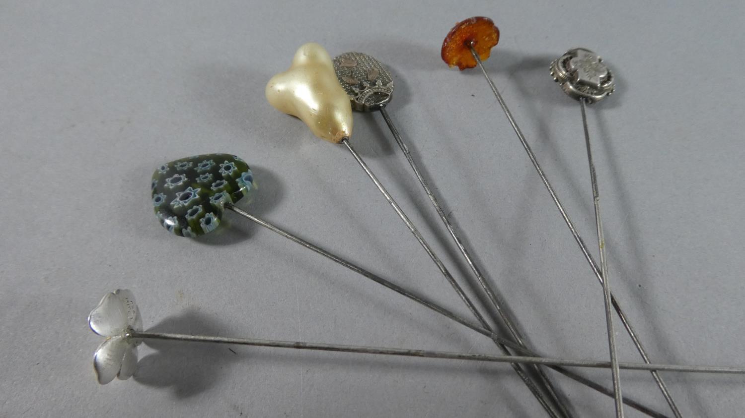 A Collection of Six Vintage Hat Pins to include silver and amber