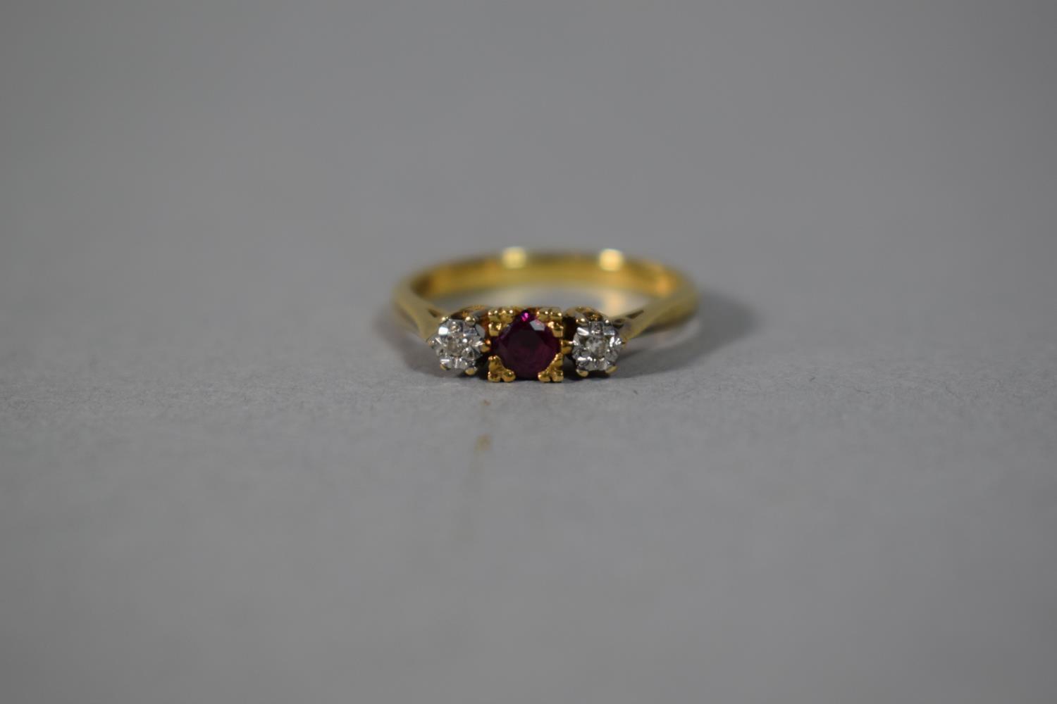 An 18 Carat Gold Ring, Set with Two Diamonds and a Ruby, Size N, 3.0gms