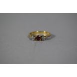 An 18 Carat Gold Ring, Set with Two Diamonds and a Ruby, Size N, 3.0gms