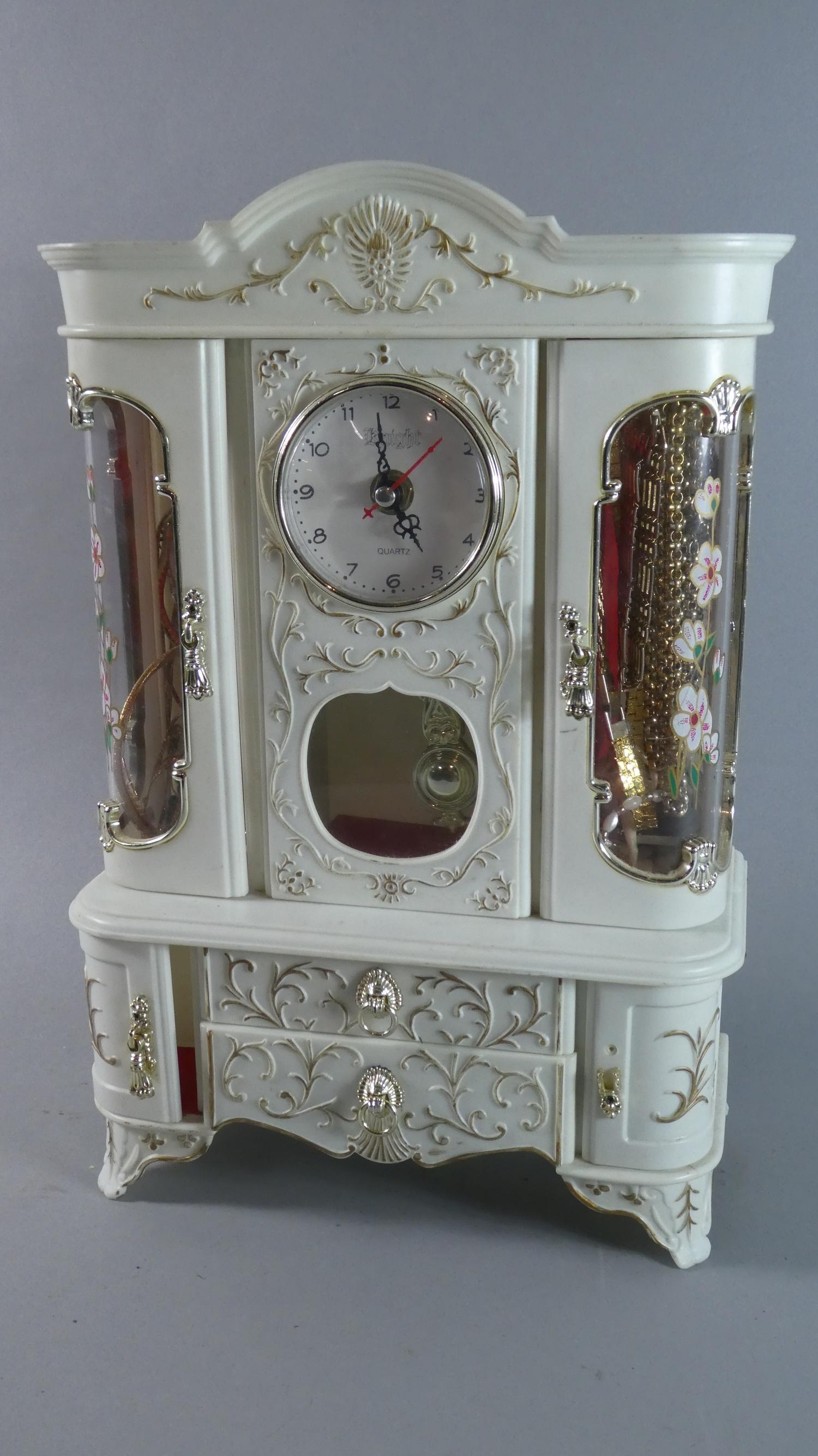 A Novelty Plastic Musical Jewellery Box in the Form of a Display Cabinet with Clock. Complete with