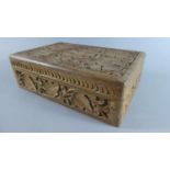 A Carved Wooden Box with Vine Leaf Decoration, 22.5cms Wide