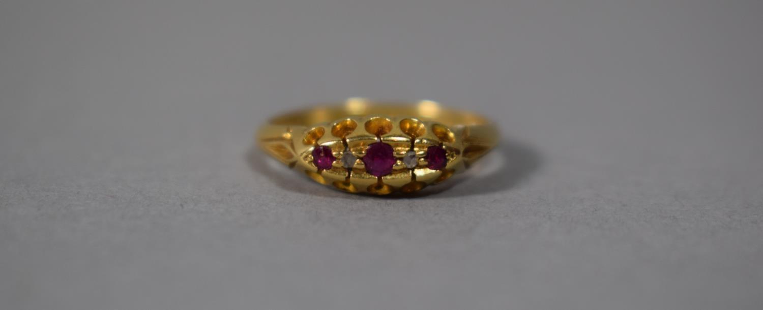 An 18 Carat Gold Ring set with Three Ruby and Diamond Chips, Chester Hallmark, Size L, 3.5gms