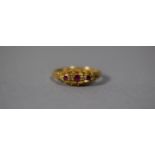 An 18 Carat Gold Ring set with Three Ruby and Diamond Chips, Chester Hallmark, Size L, 3.5gms