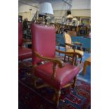 An Edwardian Oak Framed Leather Upholstered Gents Armchair with Acanthus Carving Scrolled Arms and X