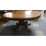 A Victorian Burr Walnut Oval Snap Top Table on Scrolled Supports with Acanthus Carving. (Missing