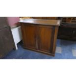 An Edwardian Mahogany Cabinet with Panelled Doors to Shelved Interior, 99cms Wide