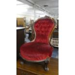 A Victorian Walnut Framed Balloon Back Ladies Nursing Chair with Buttoned Upholstery