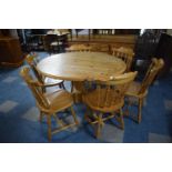 A Modern Circular Pine Dining Table with Six Chairs