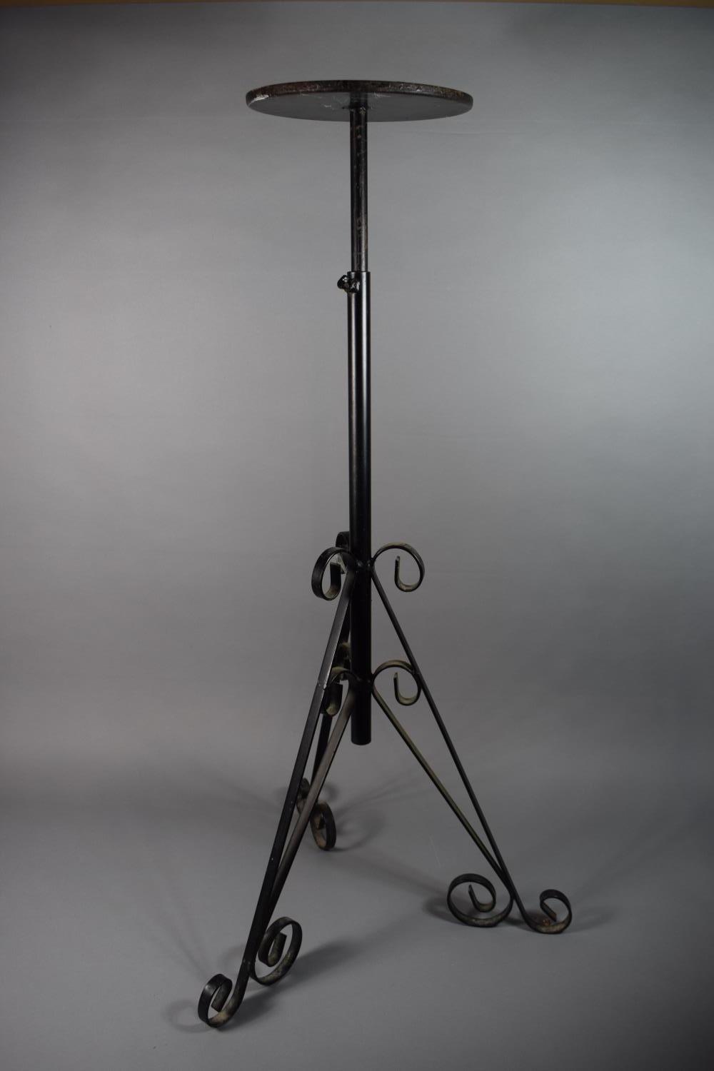 An Adjustable Wrought Iron Plant Stand with Tripod Support