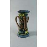 An Exeter Pottery Three Handled Vase in Usual Colour Glazes, 15cms High