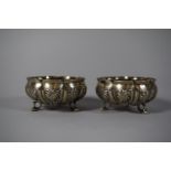 A Pair of Circular Segmented White Metal Bowls Decorated with Animals and Palm Trees, Each on