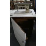 A Vintage Gold Line Emprisal Electric Sewing Machine in Painted Cabinet. Not Tested.