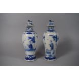 A Pair of Chinese Blue and White Slender Baluster Lidded Vases Decorated with Figures and Birds,