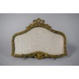 A French Ormolu Shaped Easel Back Photo Frame with Ribbon Finial, 22cms Wide