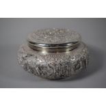 An Indian or Persian Circular Silver Lidded Box with Repousse Decoration, 17cms Diameter