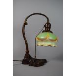 An Art Nouveau Bradley Hubbard Bronze Table Lamp with a Steuben Glass Shade Having Green Drape