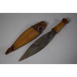 A Tribal Dagger with Wooden Handle, Leaf Blade and Carved Wooden Scabbard, Blade 20.5cms Long