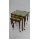 A Nest of Three Mahogany Tables with Tooled Leather Tops