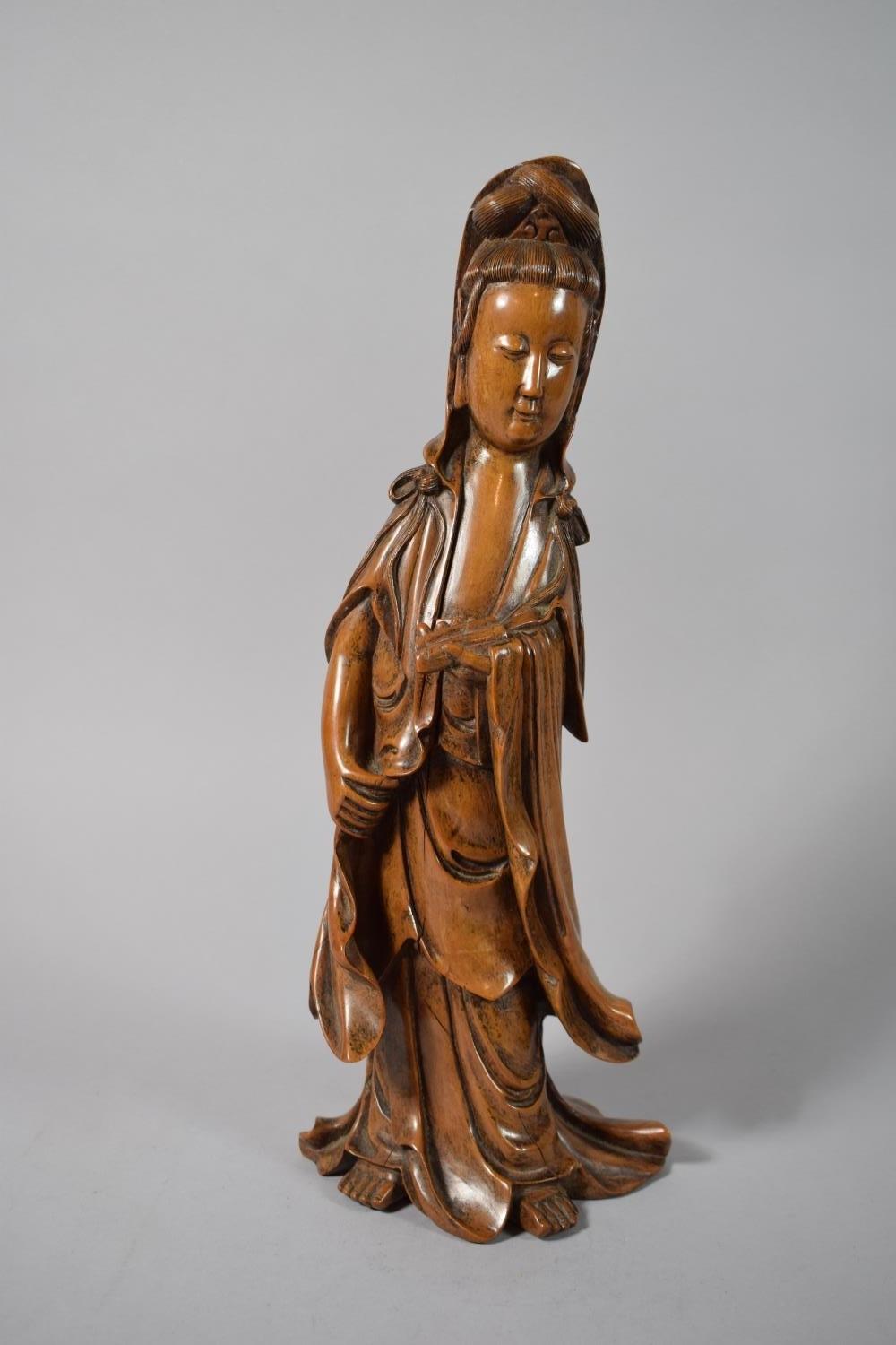 A Chinese Carved Hardwood Figure of Guanyin, 39cms High