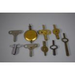 A Collection of Clock Winding Keys and a Pendulum