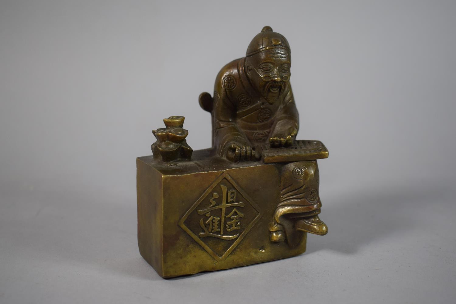 A Chinese Bronze Study of Craftsman at Work Seated on Yoke Back Chair, Four Character Stamped to