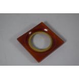 A Small Square Amber Coloured Bakelite or Celluloid Photo Frame, 9cms