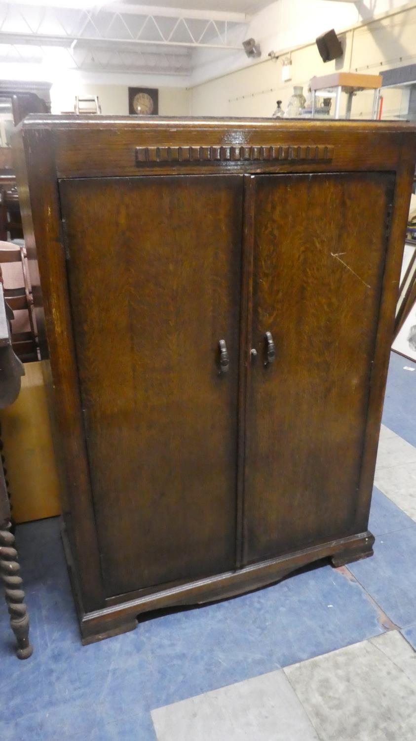 An Art Deco Oak Gents Hanging Wardrobe with Inner Tie Swivel, 77cms Wide