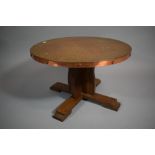 A Circular Copper Topped Coffee Table, 59cms Diameter, on Oak Base