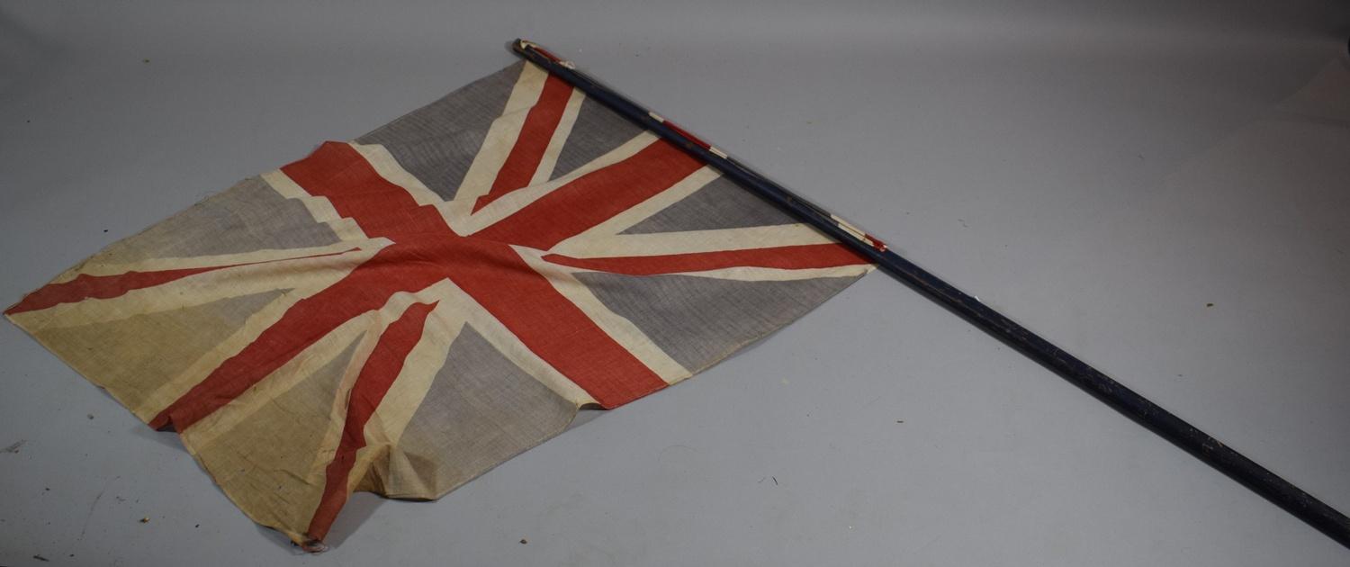 An Edwardian Cloth Union Jack (Faded and with Holes) on a Turned Wooden Flag Pole, 169cms Long