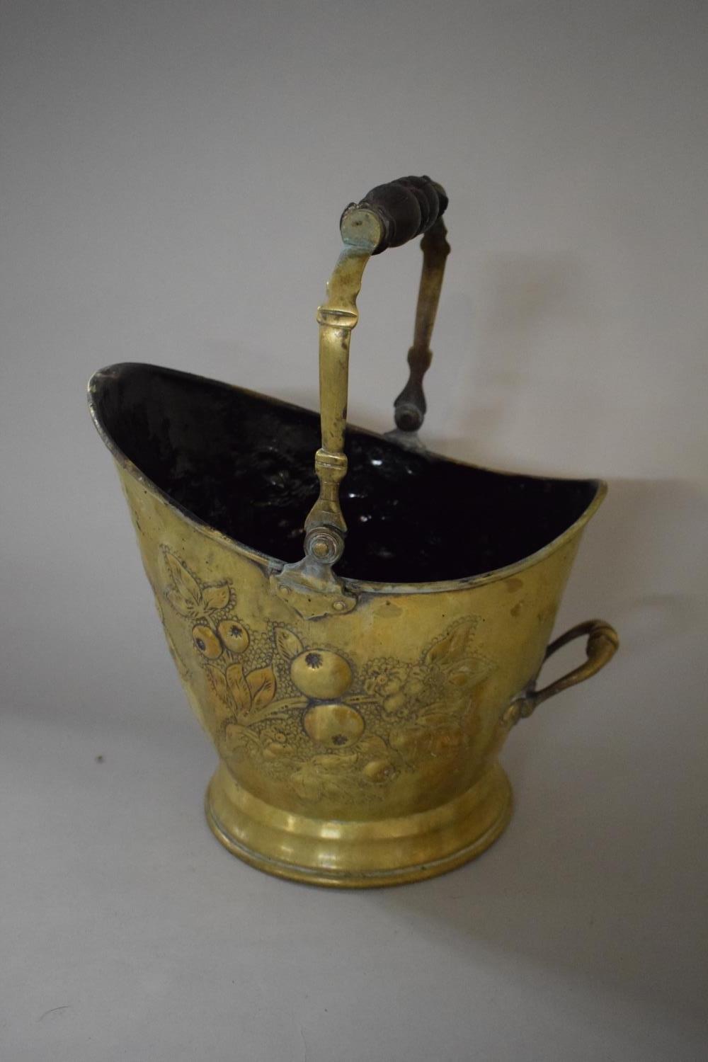 A 19th Century Brass Coal Bucket with Embossed Apple Decoration and Turned Wooden Handle, 32.5cms