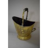 A 19th Century Brass Coal Bucket with Embossed Apple Decoration and Turned Wooden Handle, 32.5cms