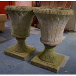 A Pair of Reconstituted Garden Urns on Square Plinth Bases, 66cms High
