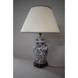 A Modern Blue and White Oriental Ceramic Lamp of Baluster Form on Wooden Stand with Shade, 39cms