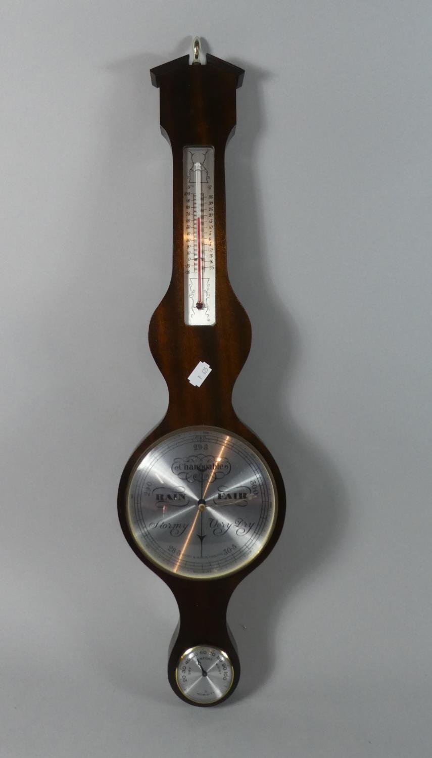 A Modern Mahogany Wheel Barometer with Humidity and Thermometer Scale, 68cms High