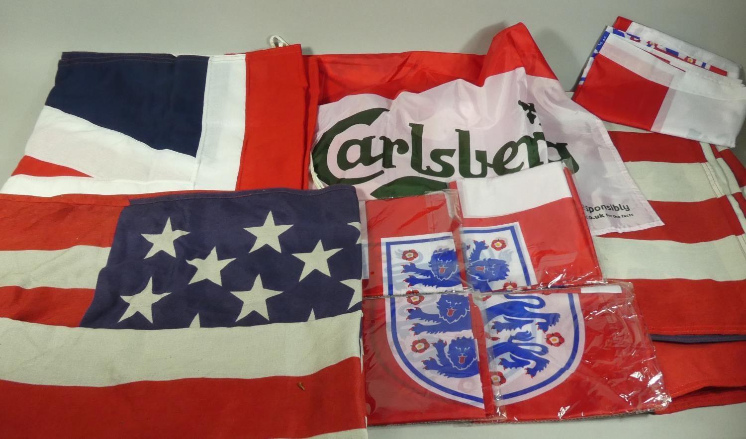 A Shoe Box Containing A Cloth Union Jack, Two American Union Flags and Six England FC Three Lions