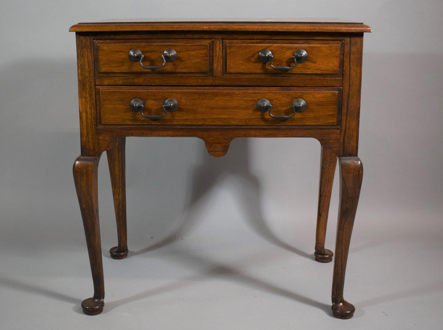 A Reproduction Lowboy with Two Short and One Long Drawers, on Cabriole Supports, 68cms Wide