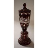 A Bohemian Ruby Glass Lidded Vase, 27cms High