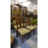 A Set of Four Edwardian Oak Dining Chairs with Inlaid Centre Splats