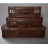 A Collection of Three Vintage Leather Suitcases, the Largest 65cms Wide