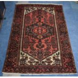 A Patterned Woollen Rug on Red Ground, Made in Iran, 190 x 128cms