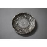 A White Metal Circular Chinese Dish with Floral Decoration and Having Inset Coin for Teng-Tien